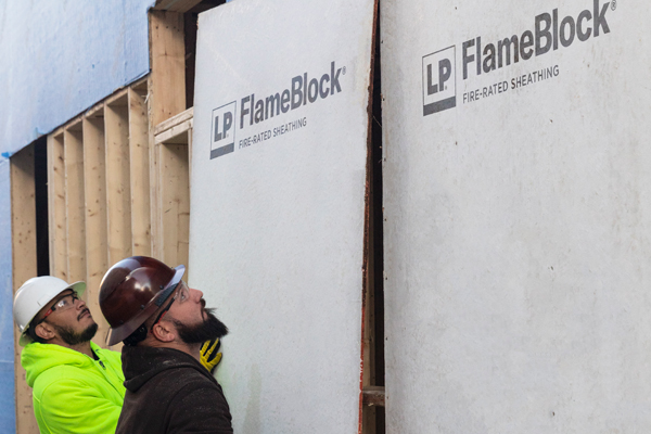 contractors installing flameblock panels